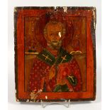 A 19TH CENTURY RUSSIAN ICON, painted with a saint. 12ins x 10.5ins.