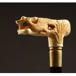 A BONE HANDLED WALKING STICK, carved as a bird and tree stump. 35ins long.