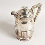 A GEORGE III SEMI FLUTED JUG, with gadrooned edge, crested. London 1815. Maker: R.E. Weight 22ozs.