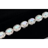 A SILVER, OPAL AND CZ LINE BRACELET.