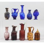 A COLLECTION OF "ROMAN" GLASS BOTTLES, some with moulded decoration as heads, bunches of grapes (