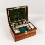 A VICTORIAN LADIES ROSEWOOD VANITY BOX, the interior with twelve glass bottles, ten with plated