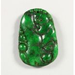 A CARVED DARK GREEN JADE PENDANT. 2ins high.