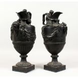 A PAIR OF WEDGWOOD BLACK BASALT EWERS, emblematic of water and wine, sacred to Neptune and