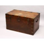 A GOOD 19TH CENTURY ANGLO INDIAN TEAK AND BRASS BOUND TRUNK, the rising top opening to reveal an