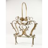 A GILT METAL MAGAZINE RACK.