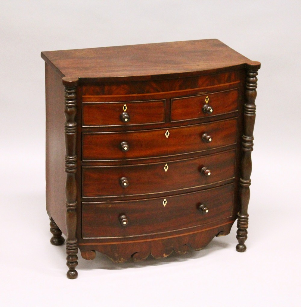 AN EARLY 19TH CENTURY MAHOGANY MINIATURE BOWFRONT CHEST, with two short and three long graduated