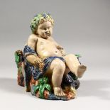 A LATE 19TH CENTURY MAJOLICA JARDINIERE, modelled as a boy Bacchus, seated by a tree stump. 9.5ins