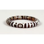 AN AGATE BANGLE. 3.25ins diameter.