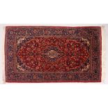 A GOOD KASHAN RUG, first half of 20th Century red ground with all-over stylized floral decoration.