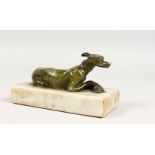 A BRONZE RECLINING WHIPPET, on a marble base. 6ins long.