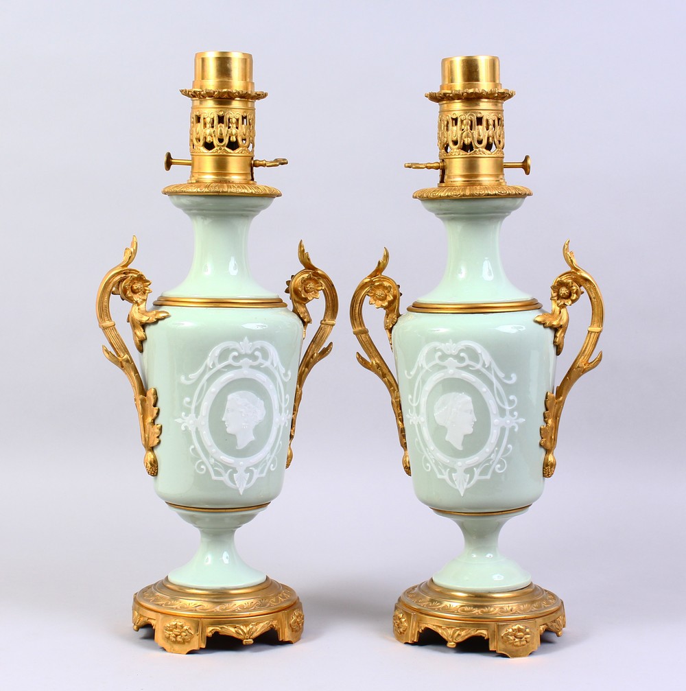 A SUPERB PAIR OF 19TH CENTURY FRENCH PATE-SUR-PATE TWO-HANDLED URN SHAPED LAMPS, inset with a