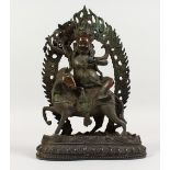 AN EASTERN BRONZE GOD, seated on a horse. 11.5ins high.