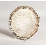 A VICTORIAN ENGRAVED SALVER, with beaded edge, on four claw and ball feet. 8ins diameter. London