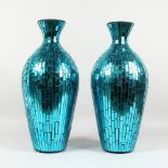 A PAIR OF STAINED GLASS STYLE TURQUOISE GLASS VASES. 1ft 9ins high.