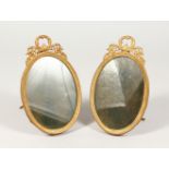 A GOOD PAIR OF ORMOLU OVAL EASEL PHOTOGRAPH FRAMES. 6ins high.