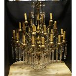A GOOD LARGE ORNATE BRASS AND CUT GLASS CHANDELIERS, in three tiers, comprising a total of thirty-