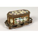 A 19TH CENTURY ORMOLU AND MOTHER-OF-PEARL INLAID CASKET, with leaf decorated base. 7.25ins wide.