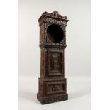 A GOOD MINIATURE CARVED OAK LONG-CASE CLOCK CASE. (No movement) 1ft 7ins high.