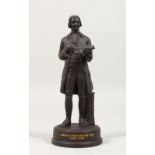 A WEDGWOOD BLACK BASALT FIGURE OF JOSIAH WEDGWOOD FRS 1730-1795, on a circular base. Inscription