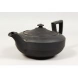 A LARGE PLAIN WEDGWOOD BLACK BASALT CIRCULAR TEAPOT AND COVER. Impressed WEDGWOOD. 6.5ins diameter.