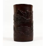 A CHINESE BAMBOO BRUSH POT, carved with a continuous landscape. 6ins high.