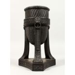 A WEDGWOOD BLACK BASALT URN, with lion ring handles, on a triangular base. Impressed WEDGWOOD.