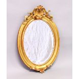 A 19TH CENTURY GILT FRAMED OVAL WALL MIRROR, with shell cresting. 2ft 11ins high x 1ft 11ins wide.