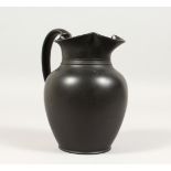 A PLAIN WEDGWOOD BLACK BASALT WATER JUG. Impressed WEDGWOOD. 7ins high.