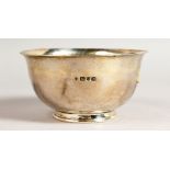 A HAMMERED CIRCULAR PEDESTAL BOWL. London 1932.