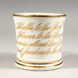 A LATE 19TH CENTURY PORCELAIN MUG, painted with flowers and anti slavery motto. 3.5ins high.