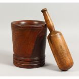 AN 18TH/19TH CENTURY LIGNUM VITAE MORTAR, with later pestle. Mortar: 7.5ins high.