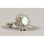 A SILVER, OPAL AND CZ CLUSTER RING.