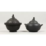 TWO WEDGWOOD BLACK BASALT CIRCULAR SUGAR BOWLS AND COVERS, the covers with female knops, one bowl