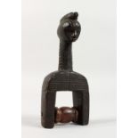 A CARVED WOOD TRIBAL HEDLEY PULLEY. 6.5ins high.