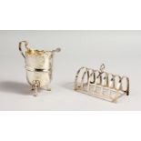 A SMALL SIX-SEGMENT TOAST RACK, Birmingham 1922, and A CREAM JUG, Birmingham 1911 (2). Toast rack