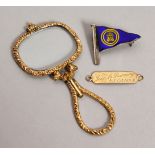 A GOLD MAGNIFYING GLASS and AN 1894 NAME TAG.