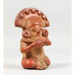 A SMALL SOUTH AMERICAN TERRACOTTA FIGURE on wooden base 5ins high.