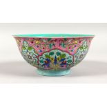A CHINESE CIRCULAR PORCELAIN BOWL, pink ground, decorated with flowers. 6.5ins diameter.