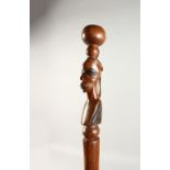 AN AFRICAN CARVED WOOD CANE. 3ft 3ins long.