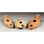 THREE ROMAN TERRACOTTA OIL LAMPS.