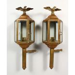 A PAIR OF BRASS CARRIAGE LAMPS with eagles. 15ins long.