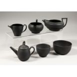 SIX SMALL PIECES OF WEDGWOOD BLACK BASALT, three jugs, two bowls and a teapot, all impressed