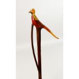 AN ENTWINED WALKING STICK, the handle carved as a pheasant. 55ins long.