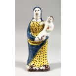 A CONTINENTAL FAIENCE POTTERY MODEL OF A MADONNA AND CHILD. 8.5ins high.