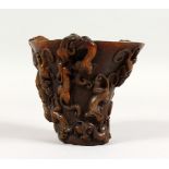 A CHINESE CARVED HORN LIBATION CUP. 5ins high.