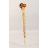 A CARVED BONE DAGGER, with incised decoration. 15.75ins long.