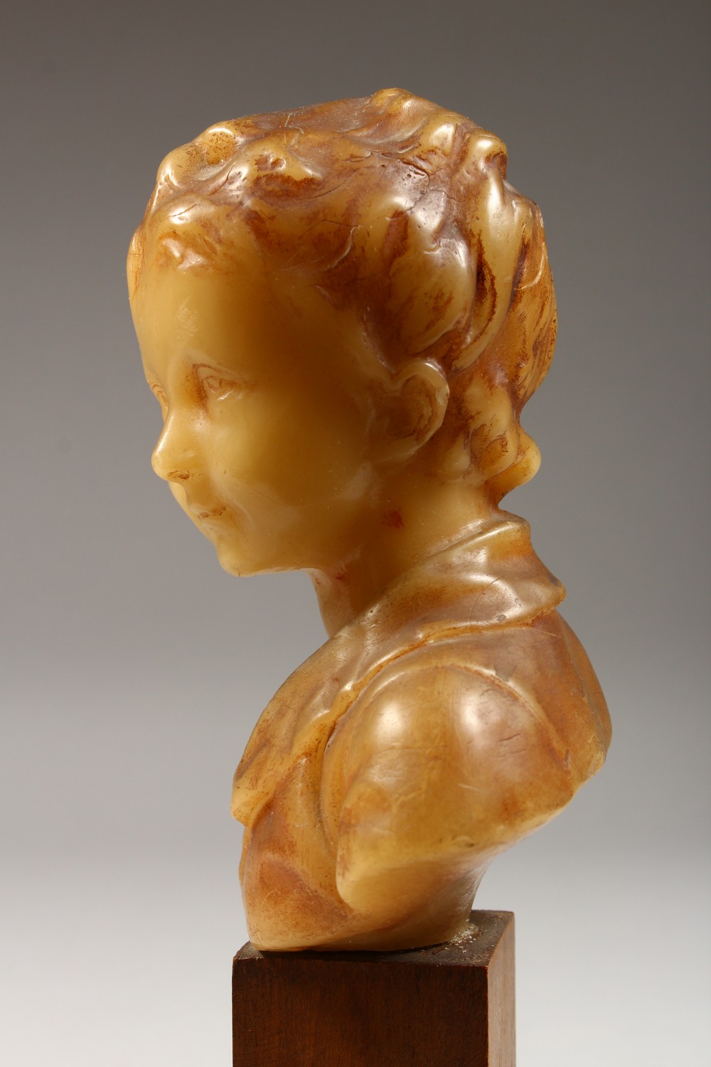 A SMALL GEORGIAN CARVED WAX BUST, head and shoulders of a young boy. 6ins high on a wooden plinth. - Image 4 of 8