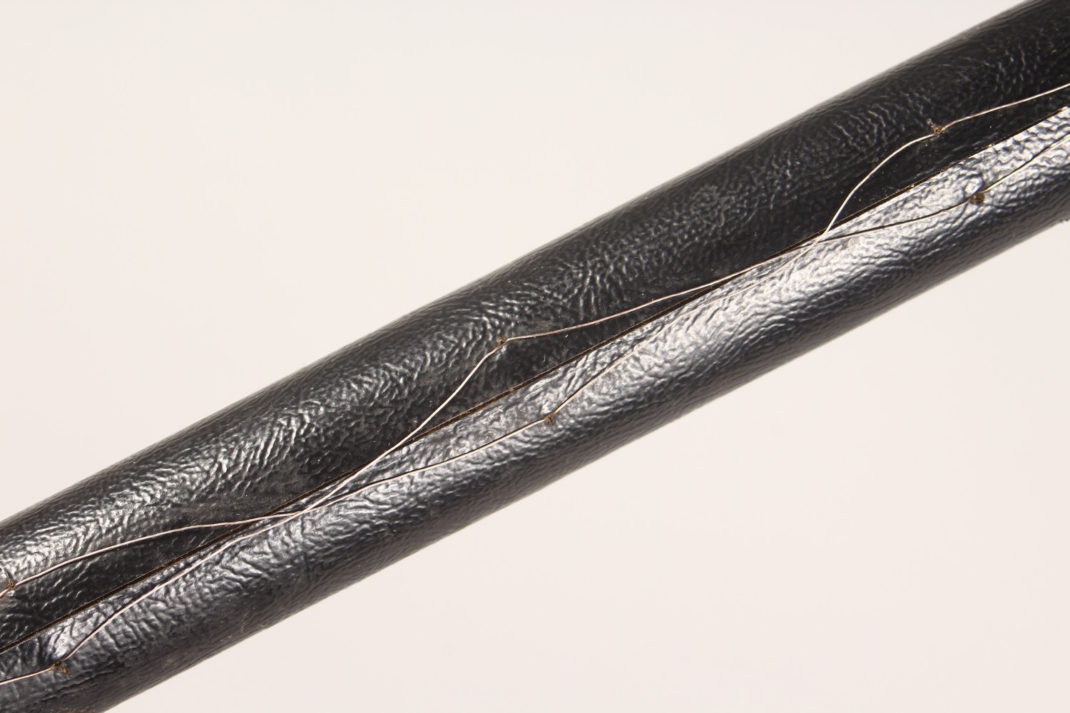 A BLACK LEATHER COVERED WALKING STICK, with eastern white metal mounts. 36ins long. - Image 6 of 11