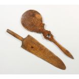 A WOODEN PADDLE, the handle with pierced hear shaped decoration, together with a spear shaped
